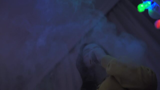 Girl smokes vape, vaping girl with e-cigarette vaping device vertical video
