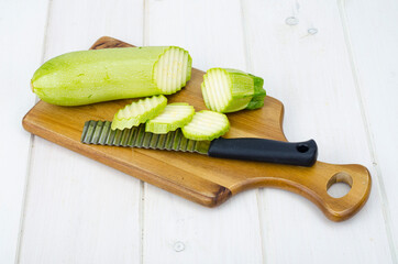 Green young fresh zucchini on wooden table for cooking