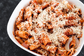 plant-based food, vegan rigatoni pasta bake with red pesto sauce and dairy free cheese before going in the oven
