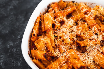 plant-based food, vegan rigatoni pasta bake with red pesto sauce and dairy free cheese