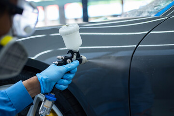 Close-up image of professional car painting, focus on the foreground.