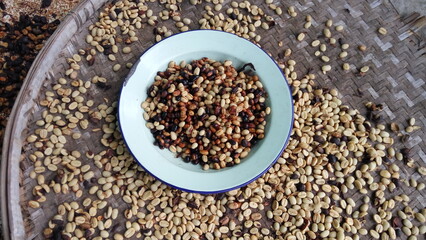 A close up photo of a plate with coffee beans in a bamboo tray