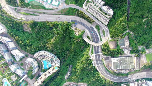 Hong Kong express highway traffic with Residential buildings and green nature surroundings, Aerial view.