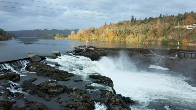 low wate rocks and spray at willamette falls on a fall morning aerial dolly backwards