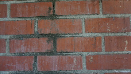 Obraz premium dirty red brick wall with black in grout