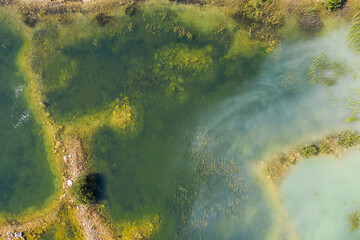 Aerial view of a shallow turquoise lake with a raised sandy bottom