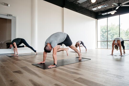 group of people doing yoga in a gym