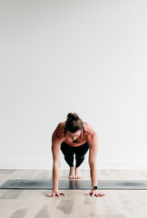 Woman holding plank pose in yoga studio portrait
