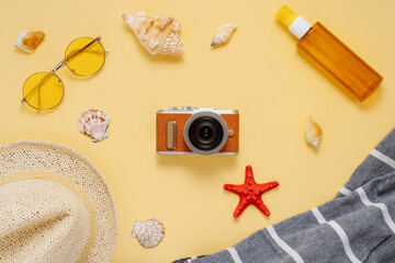 Summer beach flat lay composition top view with copy space; Image of straw hat, tanning oil,...