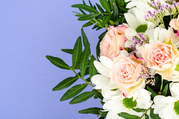 Bouquet of bright beautiful flowers on blue background