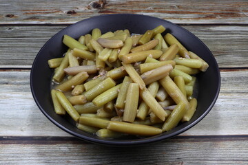Traditional fried and stirred cutting fresh lotus stem with soy sauce and pepper on the plate. Famous local vegetarian menu in Asia restaurant. High fiber and healthy menu. 