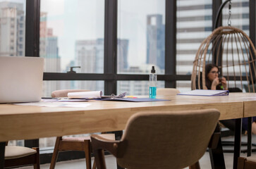 Modern office interior with blurred woman relaxing with holding cup of tea for background concept