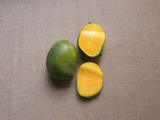 Whole and cut green and yellow color ripe Kalaphad mangoes