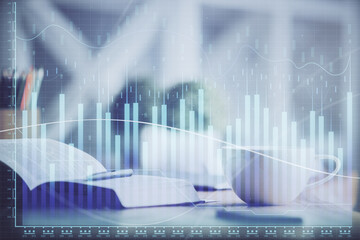 Multi exposure of forex graph drawing and desktop with coffee and items on table background. Concept of financial market trading