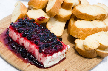 Slices of bread with white cheese and raspberry jam