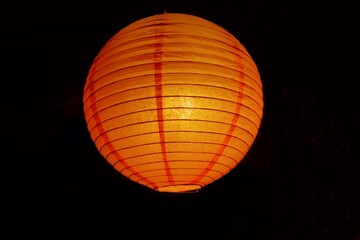 A beautiful orange paper lamp shinning in dark night, Chinese's new year festival decoration in a place 