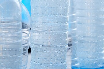 In selective focus many drinking water drolets in a plastic bottle