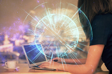 Multi exposure of woman hands typing on computer and business theme hologram drawing. Success concept.
