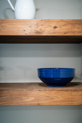 Fototapeta na wymiar blue porcelain bowl on wooden shelf