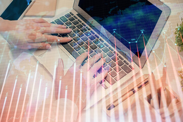Multi exposure of woman hands typing on computer and forex chart hologram drawing. Stock market...