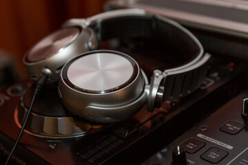 DJ headphones on soundmixer. Big night life. Holidays and events. Close-up.