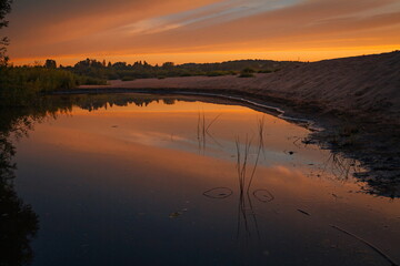 the setting sun beautifully painted the clouds in scarlet on a warm summer day