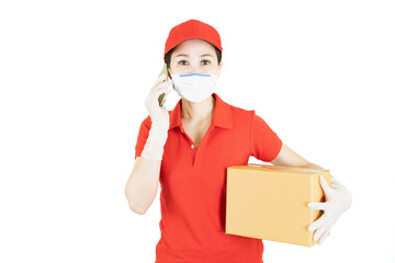 Delivery postal service asian woman in red uniform isolated on white background working as courier or dealer holding and delivering package wearing red cap,medical face mask and gloves with box.