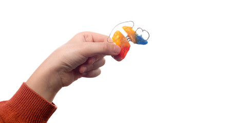 Child's hand with orthodontic appliance on a white background