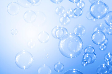 Beautiful blurry clear blue soap bubbles float background 