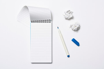 Notebook and pencil on white background
