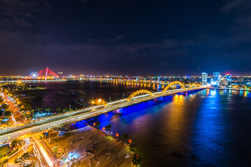 Dragon Bridge in Da Nang/Vietnam at night with colorful lights on. Twilight sky at Dragon Bridge