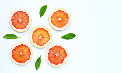 High vitamin C. Juicy grapefruit slices with green leaves on white