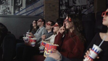 Fototapeta na wymiar Group of friends watching 3D film in cinema