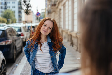 Young redhead woman standing listening