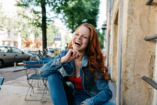 Vivacious young woman laughing uproariously
