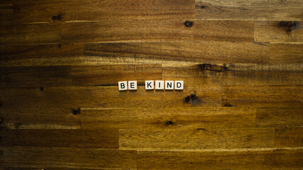 Flat lay photography - Word/s made with lettered tiles on timber background.