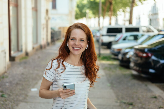 Happy grinning woman holding a mobile