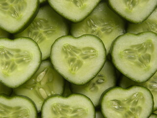 Green color sliced cut raw heart shaped cucumber	