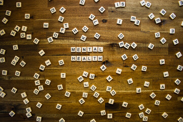 Flat lay photography - Word/s made with lettered tiles on timber background.
