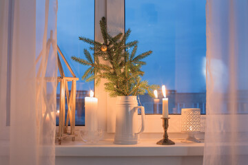 Christmas evening windowsill with burning candles