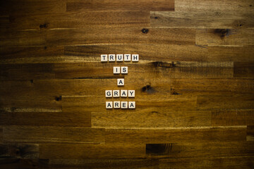 Flat lay photography - Word/s made with lettered tiles on timber background.