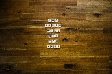 Flat lay photography - Word/s made with lettered tiles on timber background.
