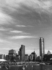 Men fishing, Santiago skyline with sky with clouds (in black and white)