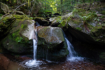 A small double waterfall deep in the woods