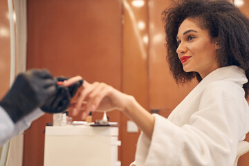 Positive Afro American woman in beauty salon