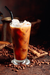 Ice coffee with cream being poured into it showing the texture and refreshing look of the drink.