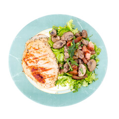 Grilled chicken breasts and lettuce green leaves with champignons. Studio Photo