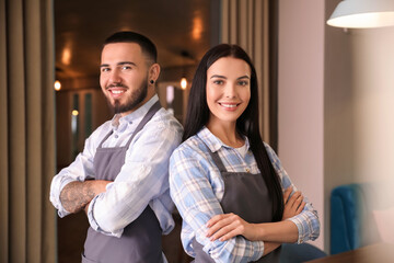 Portrait of young waiters in restaurant