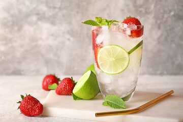 Glass of fresh strawberry lemonade on table