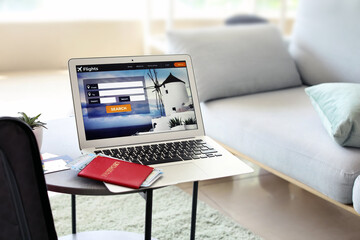 Open page of online booking service on screen of laptop at home